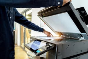 Business man Hand press button on panel of printer, printer scanner laser office copy machine supplies start concept.