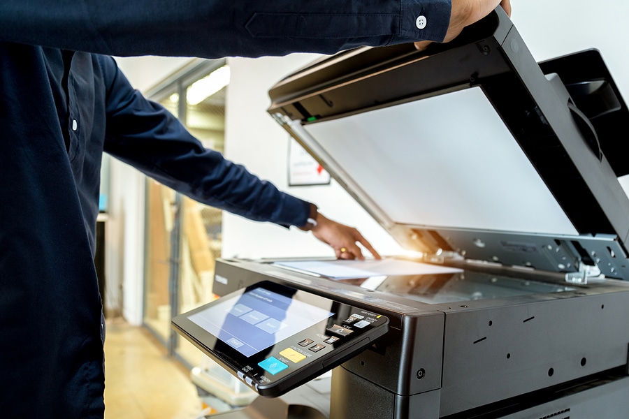 Business man Hand press button on panel of printer, printer scanner laser office copy machine supplies start concept.