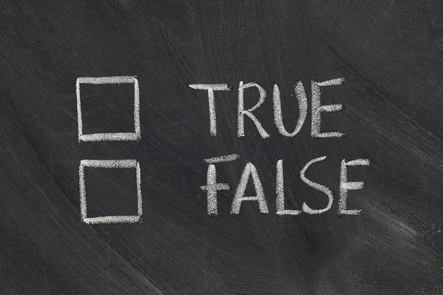 White chalk handwriting on blackboard showing true or false options with checkboxes