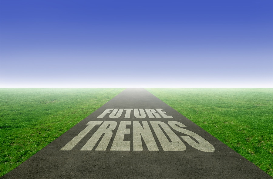 The words FUTURE TRENDS are written on an open road leading towards the horizon.