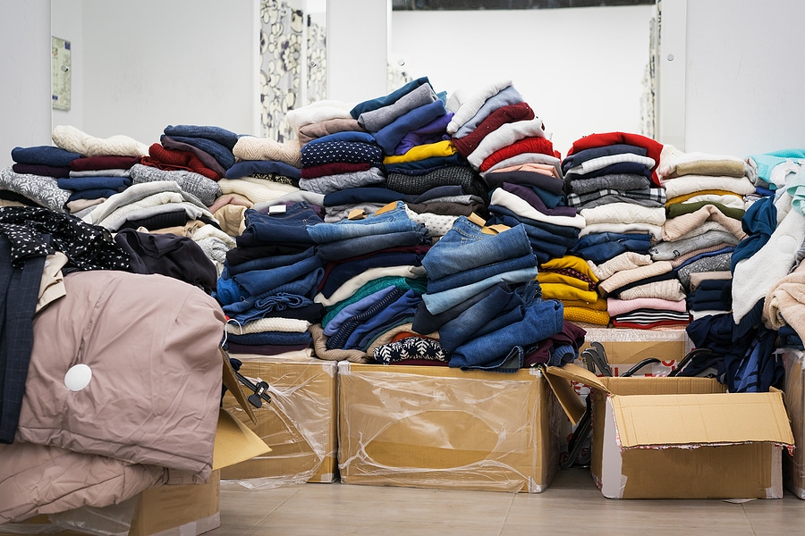 A collection of jeans, sweaters and jackets in a storage room